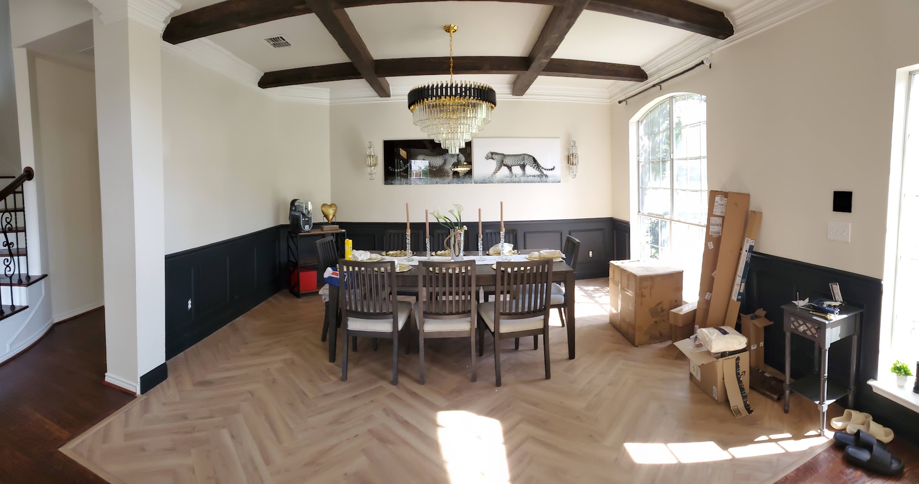 Completed dining room with painted finishes and custom ceiling beams