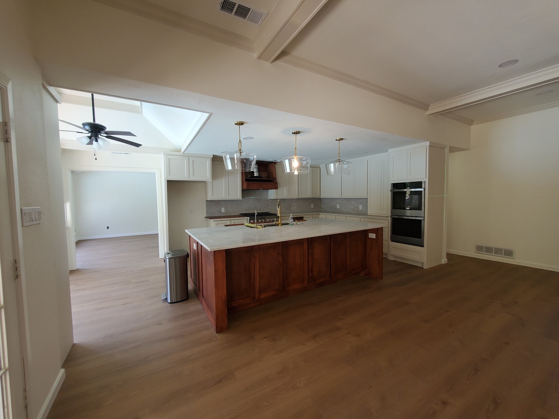 Open kitchen with finished cabinetry and flooring