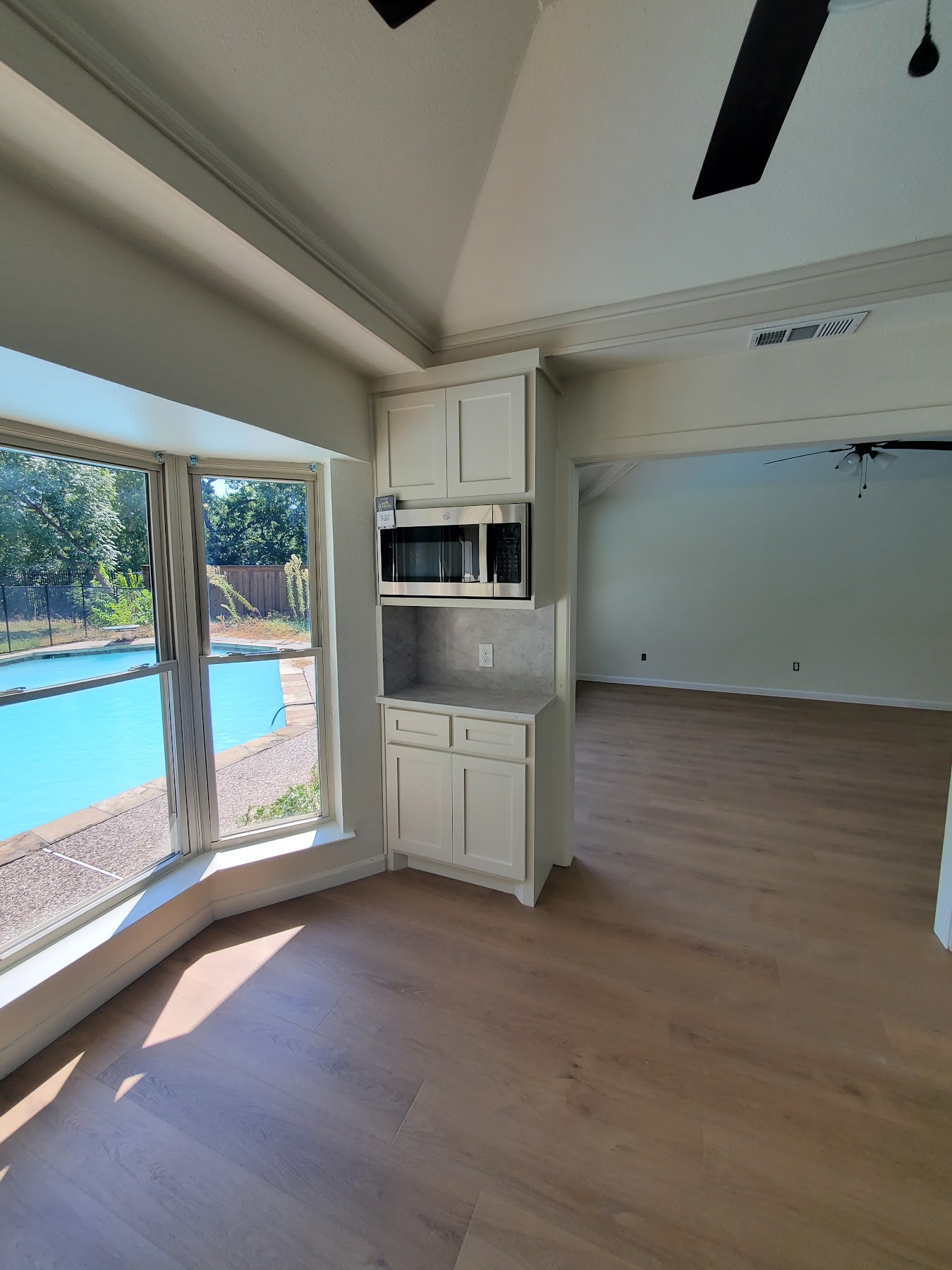 Completed pool-facing living space with new flooring and built-ins